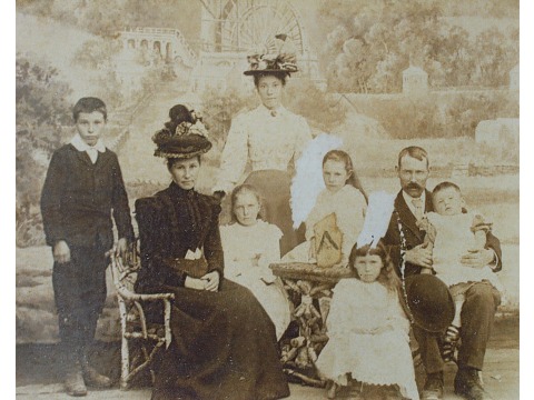 Family group portrait. From left to right: Mrs Joyce Kinley's Uncle Fred Crowe, grandmother Catherine Margaret Crowe nee Corlett, Aunty Leana Crowe (grandfatherÃÂ¢ÃÂÃÂs sister), the three young girls in centre are Ethel, Jessica and Winnie (correct order unknown), grandfather George Daniel Crowe and Mrs Joyce KinleyÃÂ¢ÃÂÃÂs father George Henry is on his fatherÃÂ¢ÃÂÃÂs lap. Date unknown