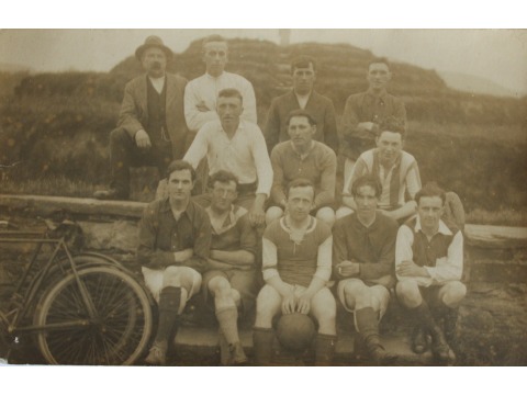 Mrs Joyce Kinley's father George Crowe is sitting centre in the middle row in front of Tynwald Hill at St John's. Bisset Kewley, wearing a bowler hat, is standing in the back row far left. Date unknown