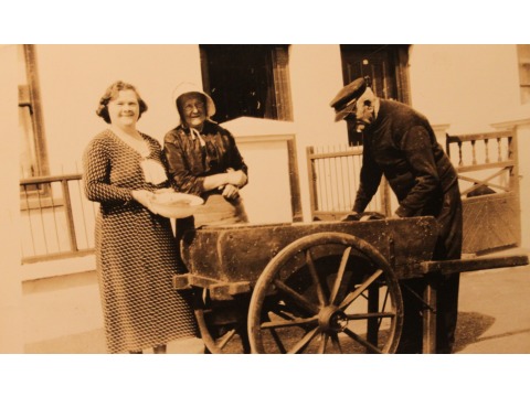 Mrs Jessie Fayle's mother Mrs Clucas is on the left with Miss Watterson (Captain Watterson's sister) buying fish from John Quirk in Peel. Date unknown