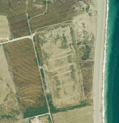 An aerial view of Wright's Pit East, just south of the Point of Ayre. Although it has now been landscaped its oblong shape is clearly visible and its south eastern corner is dangerously close to the eroding sea cliffs.