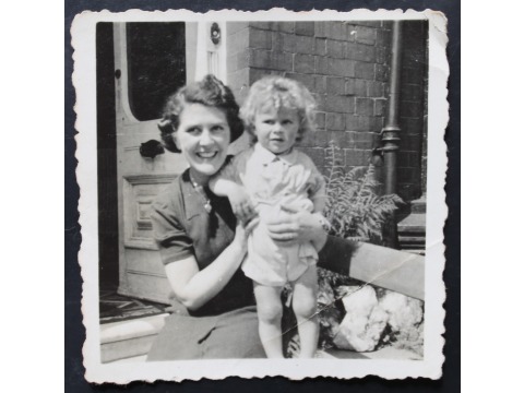 Mrs Betty Magee with a friend's son outside her house in 1943